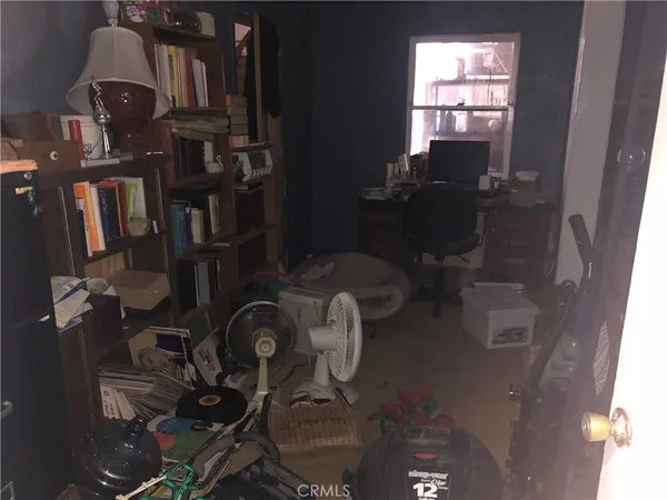 a kitchen with a refrigerator and a wooden floor