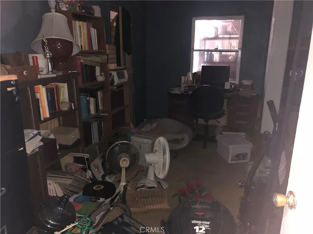 a kitchen with a refrigerator and a wooden floor