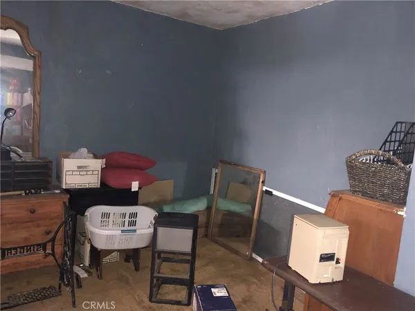 a bedroom with a dresser and a mirror