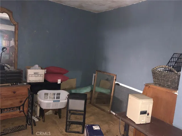 a bedroom with a dresser and a mirror