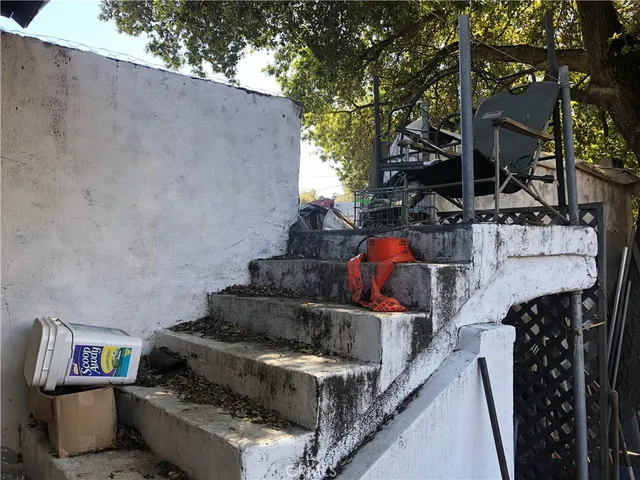 a view of a chairs and table in backyard