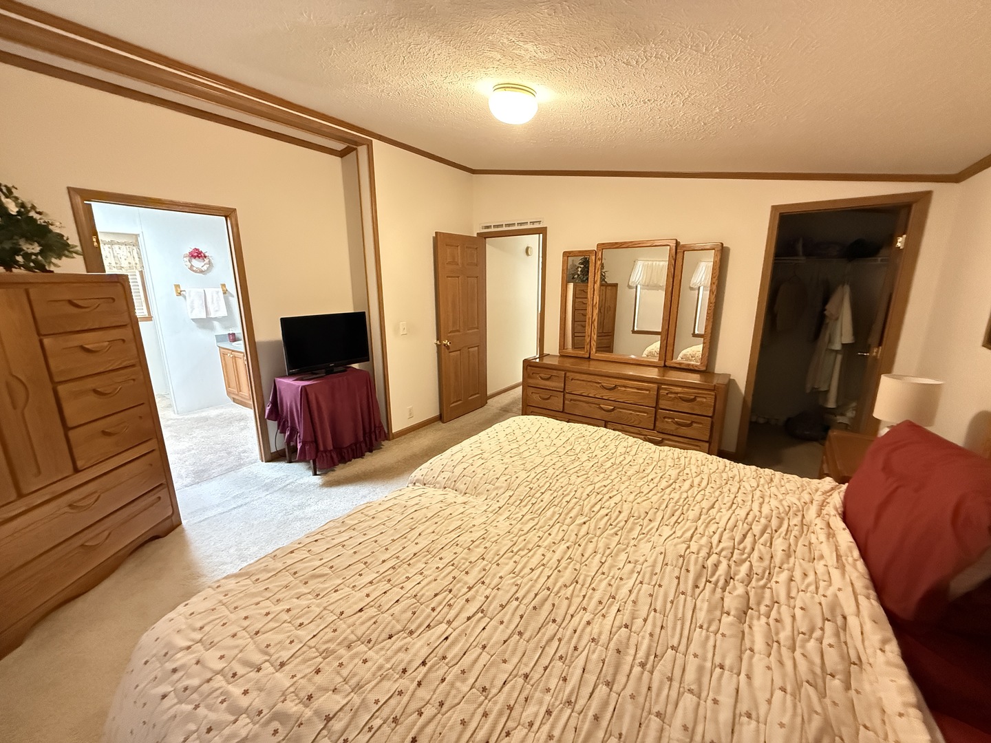 4 Cynthia Lane Beecher, IL 60401 - Photo 18 of 20 a bedroom with a bed and a flat tv screen on dresser