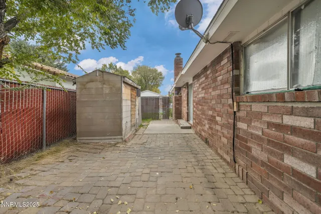 a view of wooden house with a small yard