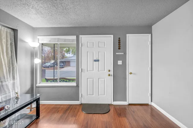 a living room with furniture wooden floor and a flat screen tv