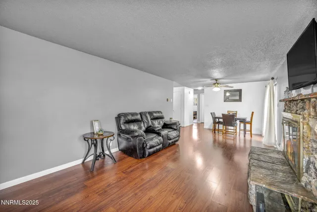 a living room with furniture a flat screen tv and a fireplace