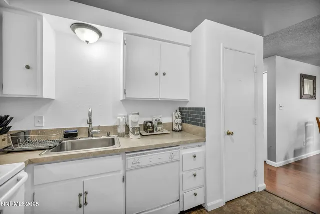 a kitchen with stainless steel appliances granite countertop a sink a stove and a granite counter tops