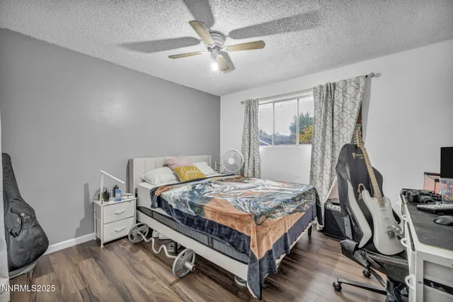 a bedroom with a bed table and a window