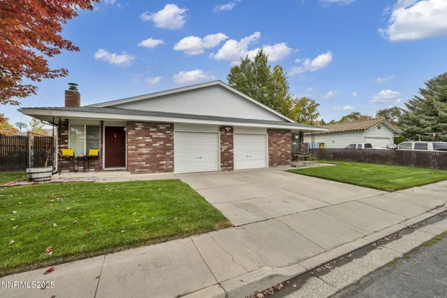 a view of a white house with a big yard and potted plants