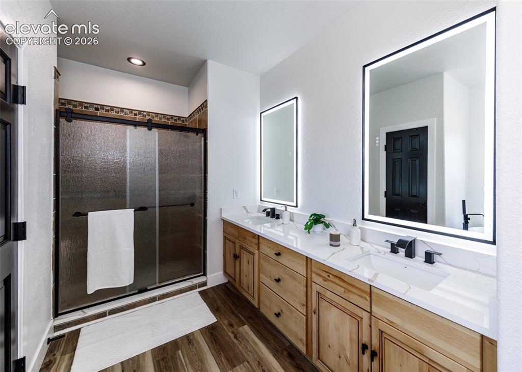 1120 Newton Road Pueblo, CO 81005 - Photo 15 of 46 a bathroom with double vanity and a mirror