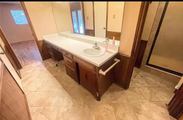a bathroom with a sink vanity and a mirror