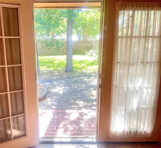 a view of empty room with wooden floor and front door