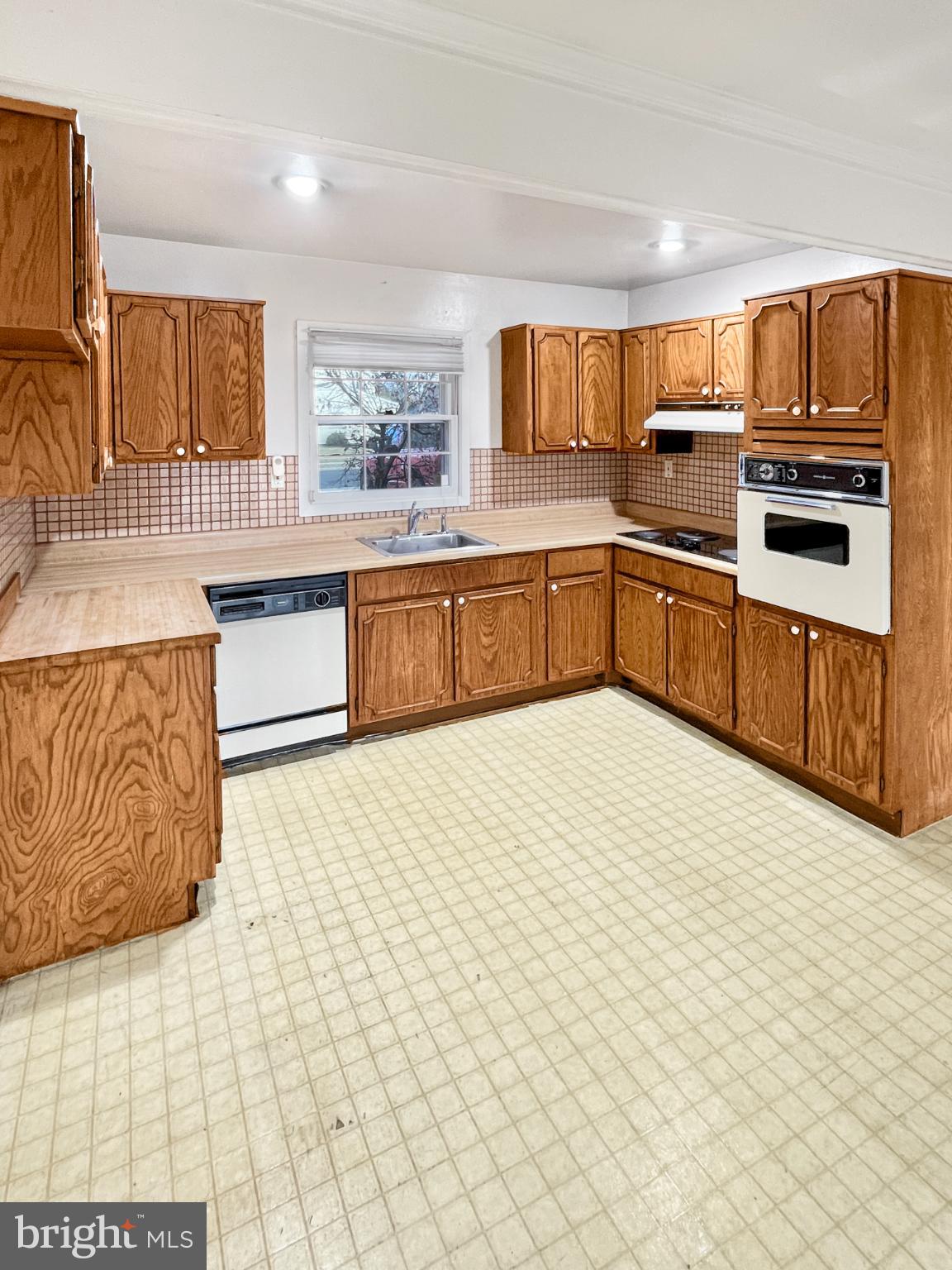 34 East River Drive Willingboro, NJ 08046 - Photo 7 of 15 a kitchen with stainless steel appliances a sink a stove top oven a chimney and a center island