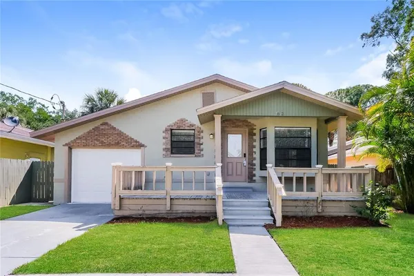 a front view of a house with a garden and deck