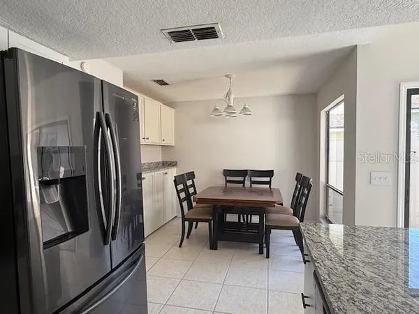 a kitchen with granite countertop a sink appliances and cabinets
