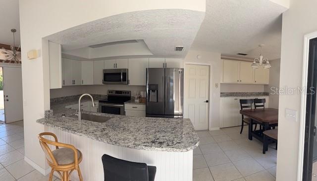 4513 Dewey Drive New Port Richey, FL 34652 - Photo 12 of 29 a kitchen with granite countertop a sink appliances and cabinets