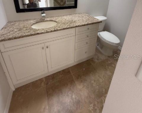 4513 Dewey Drive New Port Richey, FL 34652 - Photo 19 of 29 a bathroom with a granite countertop sink and a toilet