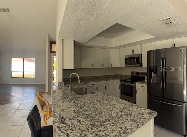 4513 Dewey Drive New Port Richey, FL 34652 - Photo 26 of 29 a kitchen with stainless steel appliances granite countertop a sink stove and refrigerator