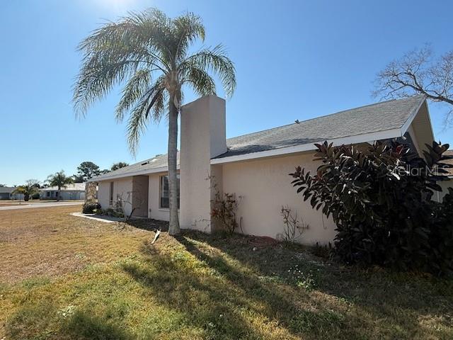 4513 Dewey Drive New Port Richey, FL 34652 - Photo 28 of 29 a view of a house with a yard and potted plants