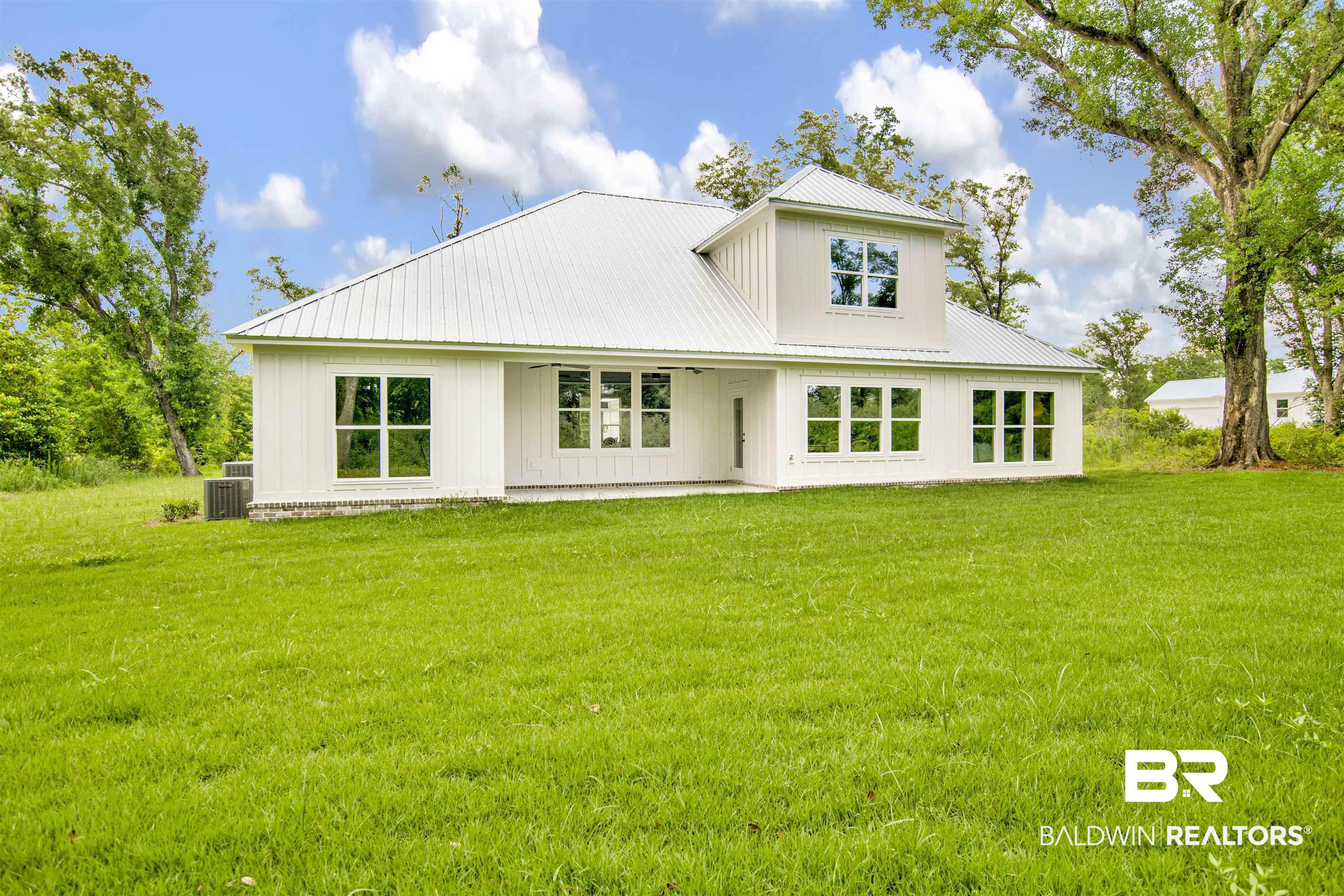 9275 Clarke Ridge Road Foley, AL 36535 - Photo 38 of 43 Rear view of property featuring a yard, metal roof, a patio, and cooling unit