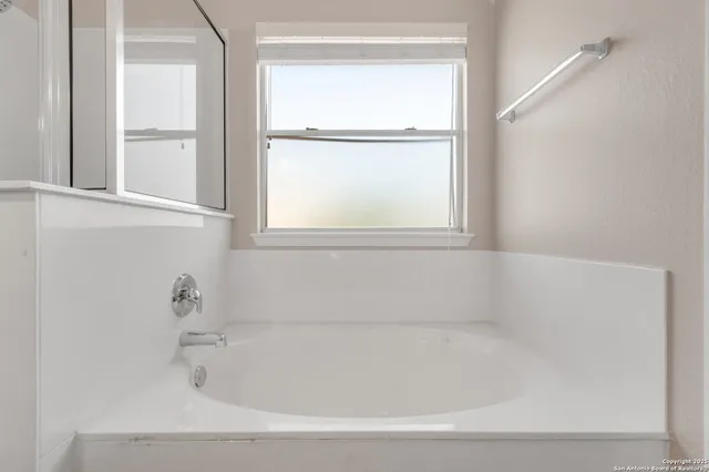a white bath tub sitting next to a window