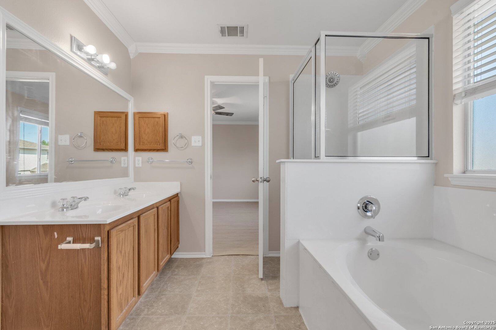 5644 Brougham Way Austin, TX 78754 - Photo 14 of 31 a bathroom with a tub a sink and mirror