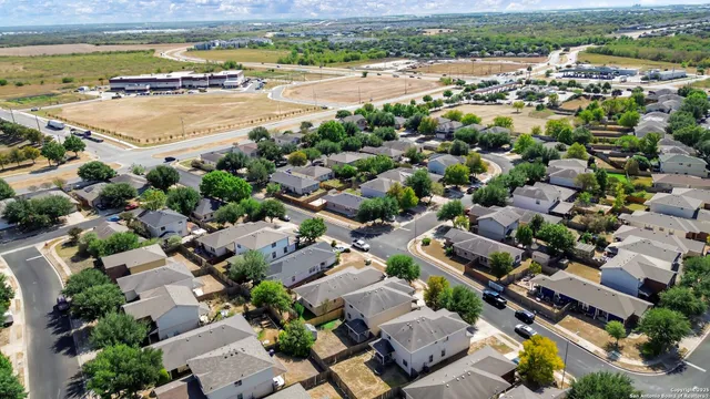 an aerial view of residential houses with outdoor space