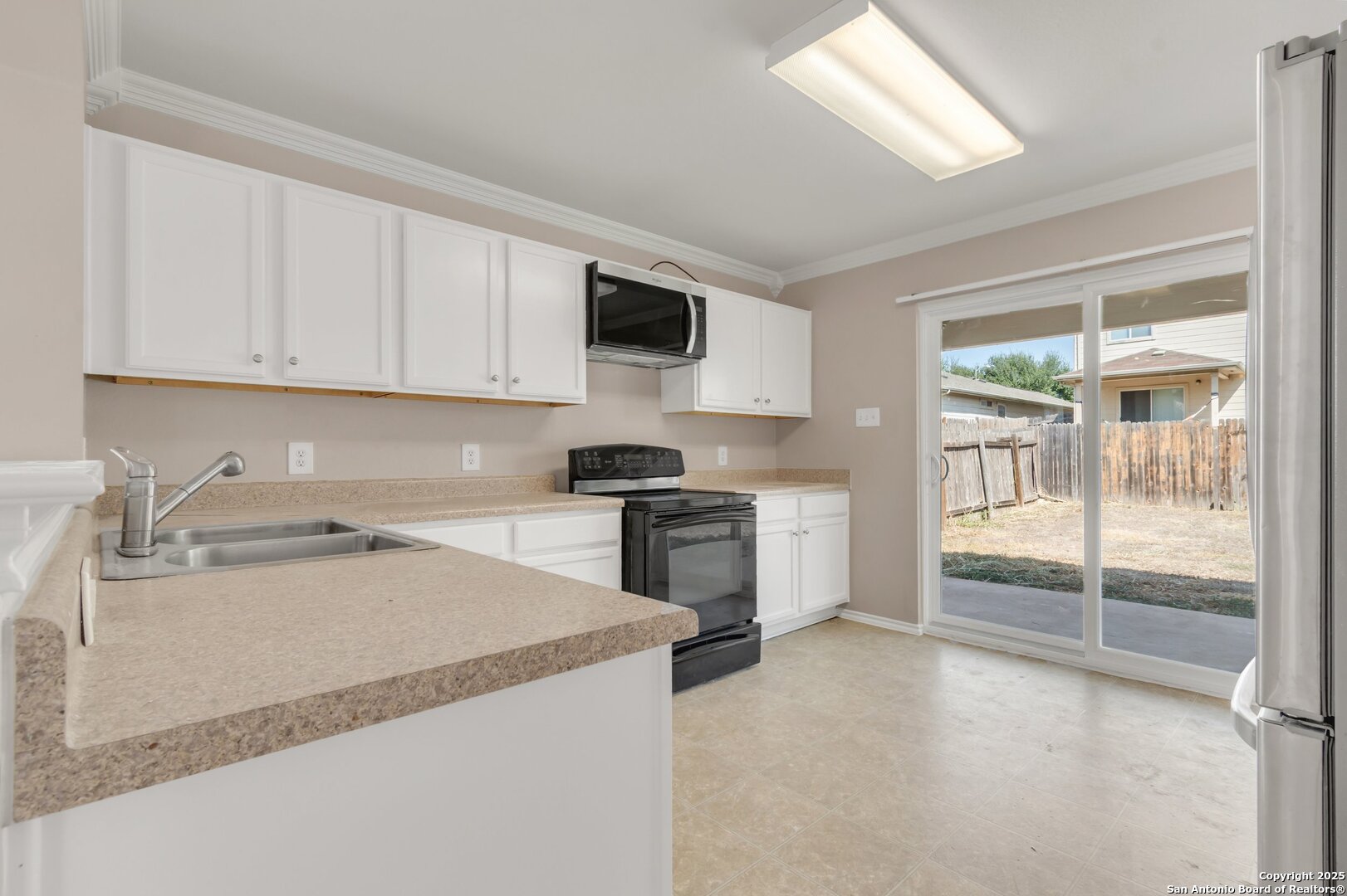 5644 Brougham Way Austin, TX 78754 - Photo 4 of 31 a kitchen with a stove a sink and a refrigerator