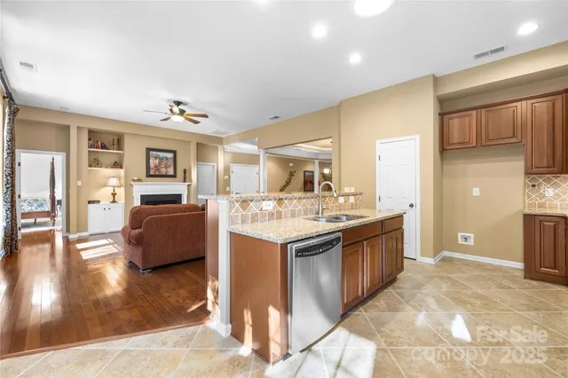 a kitchen with stainless steel appliances granite countertop a sink and cabinets