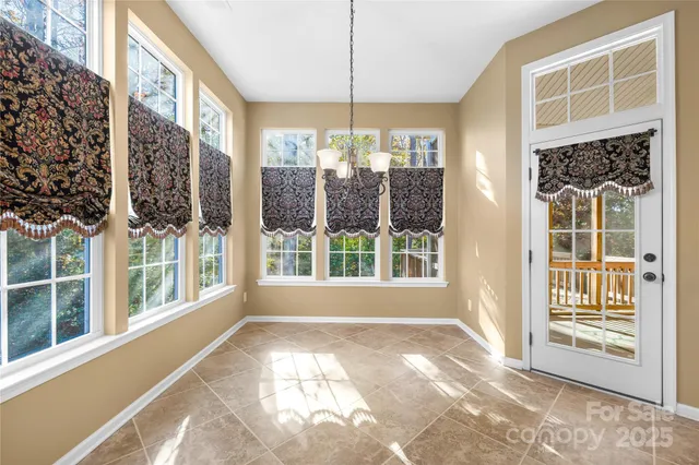 a view of a room with a large window and furniture