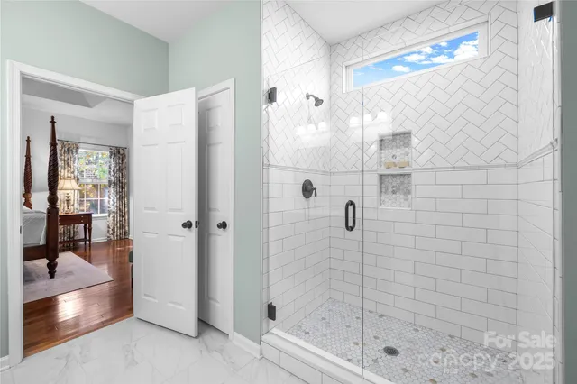 a living room with furniture a fireplace and a chandelier