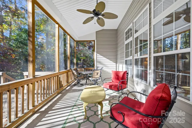 a view of balcony with wooden floor and fence