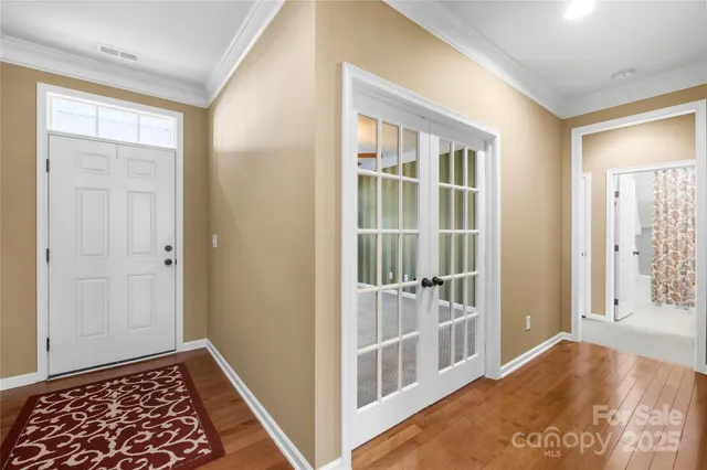 a view of hallway with wooden floor and windows