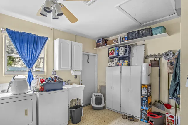 a view of a kitchen with fridge and window