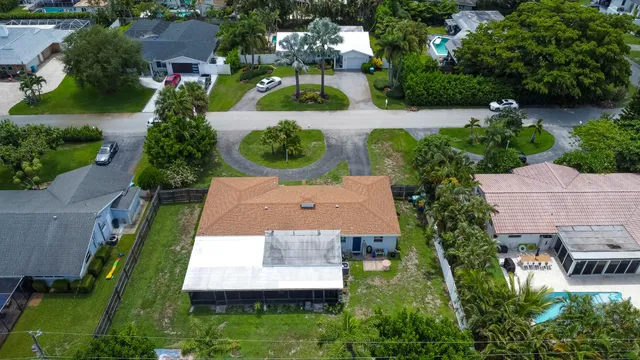an aerial view of a house with garden space and street view