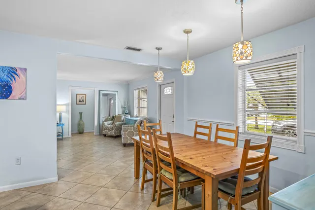 a dining room filled with furniture and wooden floor