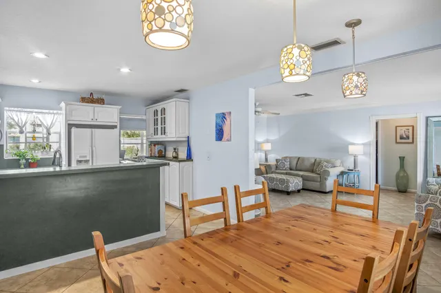 a living room with kitchen island furniture and a chandelier
