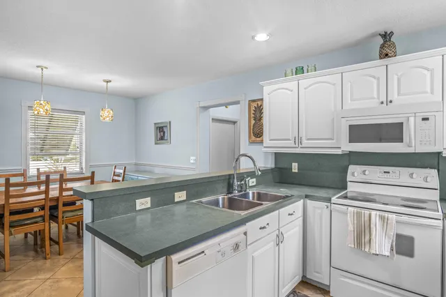 a kitchen that has a sink and a stove in it