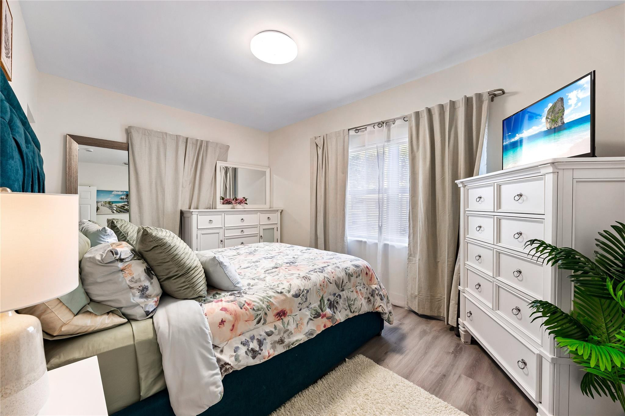 218 Southwest 7th Street Dania Beach, FL 33004 - Photo 29 of 57 a bedroom with a bed couch and a large window