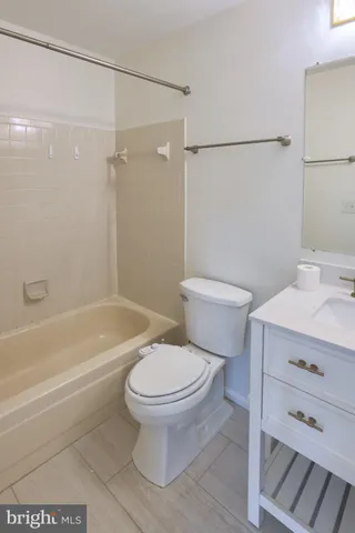 a bathroom with a toilet and a bathtub