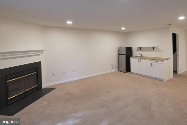 a view of an empty room with a fireplace