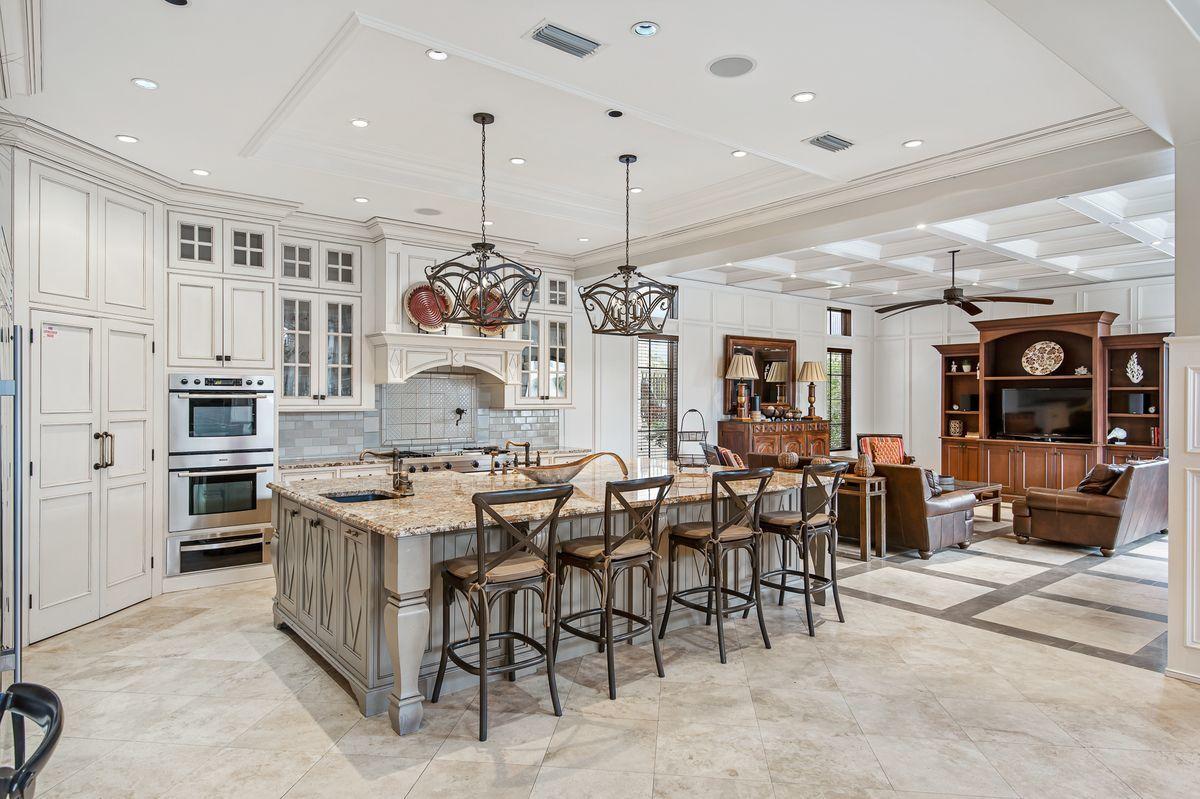 4789 Ocean Boulevard Destin, FL 32541 - Photo 16 of 47 a large kitchen with a table and chairs