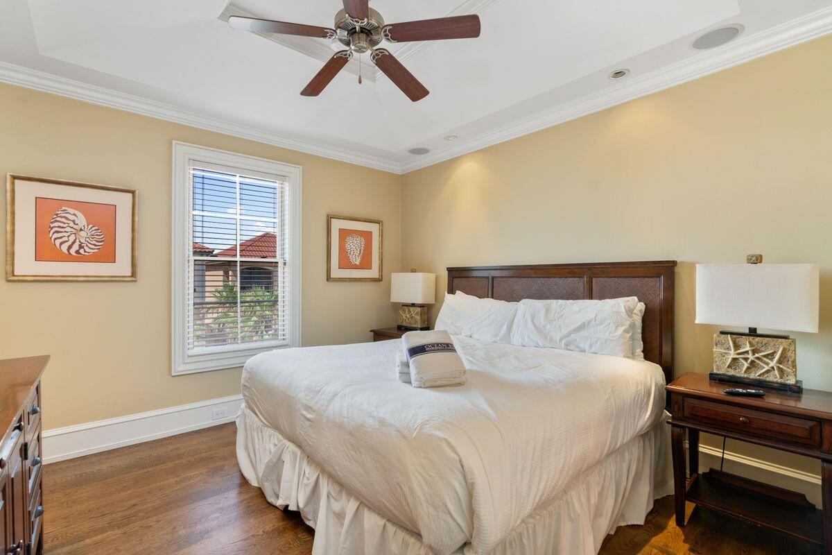 4789 Ocean Boulevard Destin, FL 32541 - Photo 27 of 47 a bedroom with a bed and wooden floor