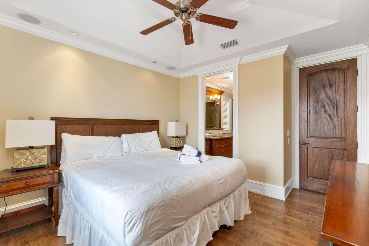 4789 Ocean Boulevard Destin, FL 32541 - Photo 28 of 47 a bedroom with a bed and wooden floor