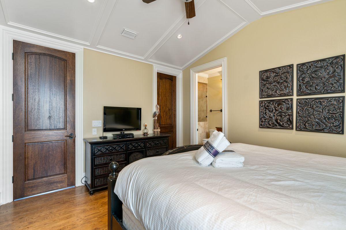 4789 Ocean Boulevard Destin, FL 32541 - Photo 30 of 47 a bedroom with a bed and a flat screen tv