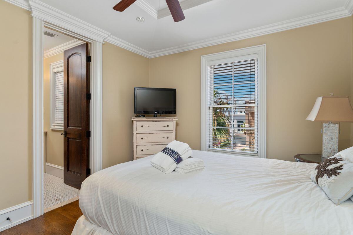 4789 Ocean Boulevard Destin, FL 32541 - Photo 38 of 47 a bedroom with a bed and a flat tv screen on dresser