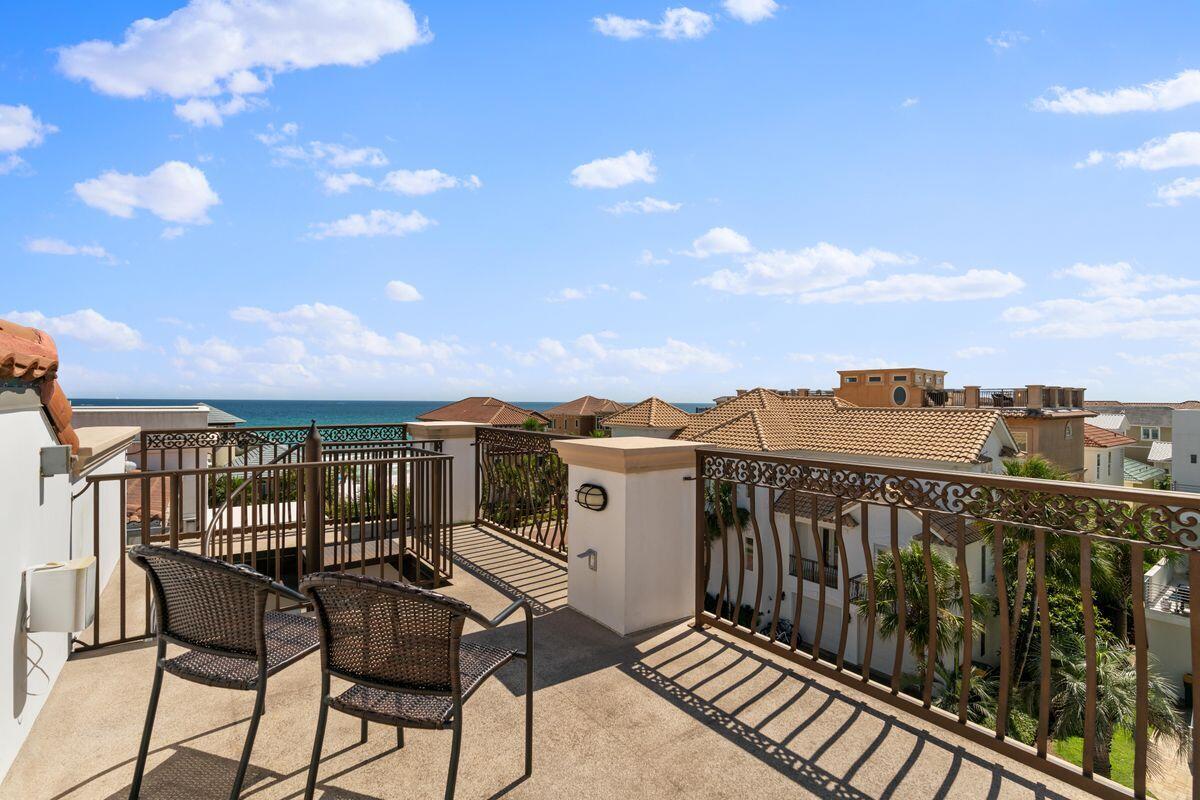 4789 Ocean Boulevard Destin, FL 32541 - Photo 44 of 47 a view of a balcony with wooden chairs