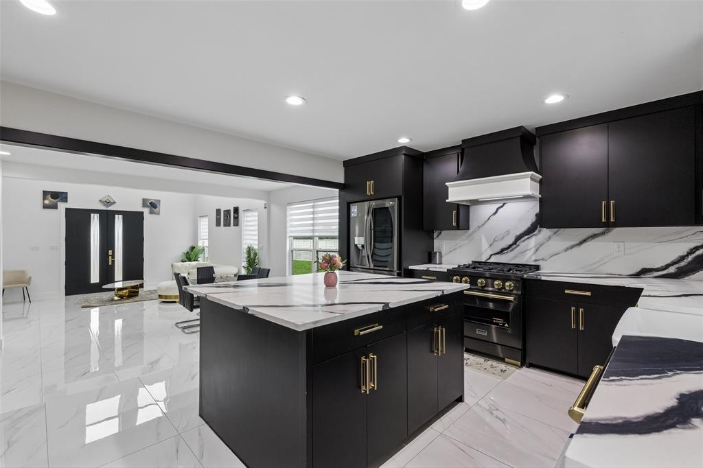 1053 Sedalia Road Van Alstyne, TX 75495 - Photo 12 of 40 a kitchen with granite countertop a sink and stove