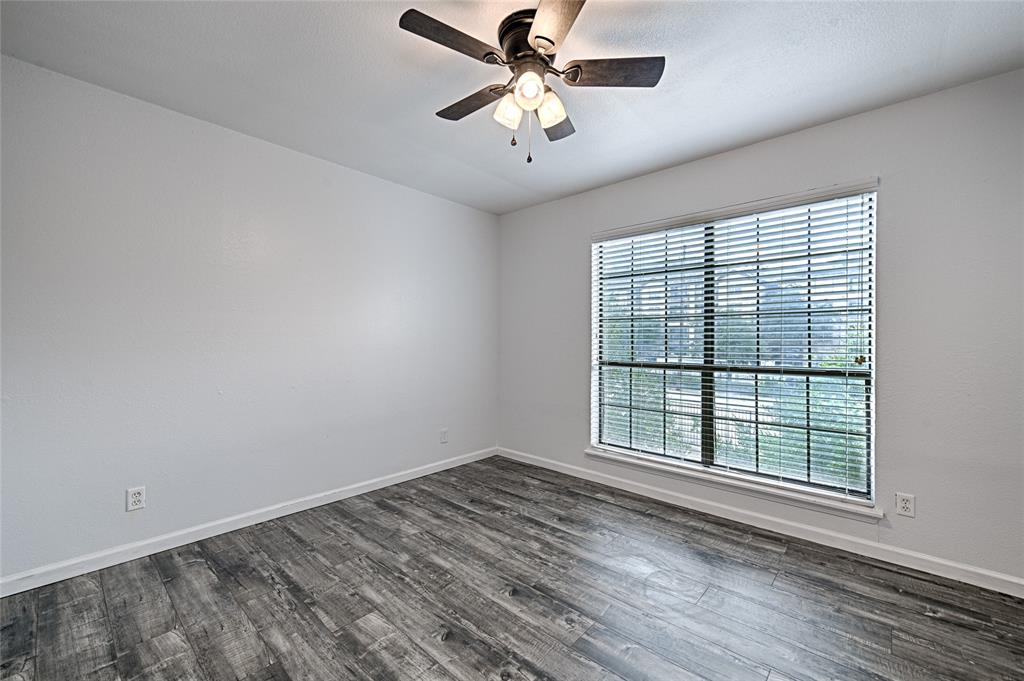 8545 Midpark Road, Unit 2 Dallas, TX 75240 - Photo 17 of 19 wooden floor in an empty room with a window