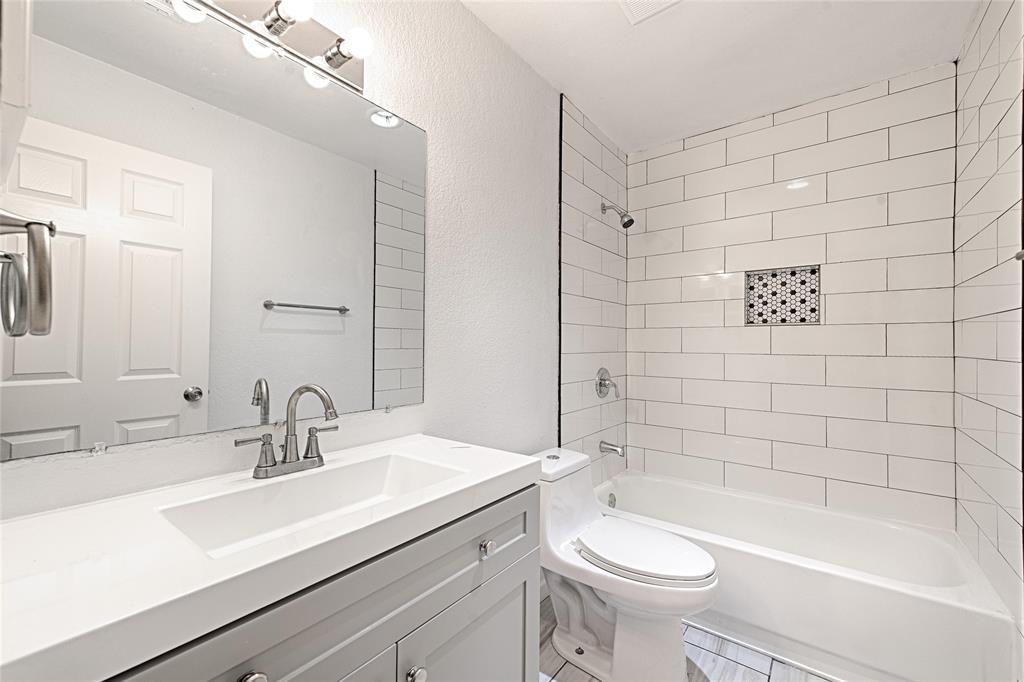 8545 Midpark Road, Unit 2 Dallas, TX 75240 - Photo 19 of 19 a bathroom with a sink a toilet and shower