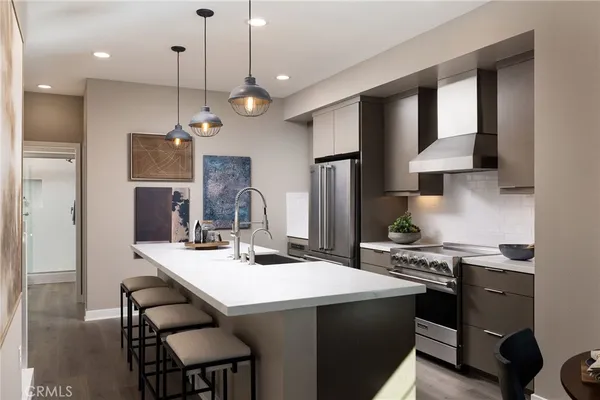 a kitchen with sink stove and refrigerator
